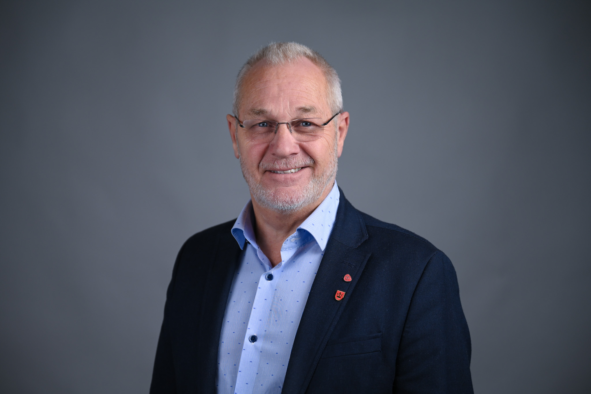 Portrett av mann med grå bakgrunn. Foto: Anders Palmer Holmen