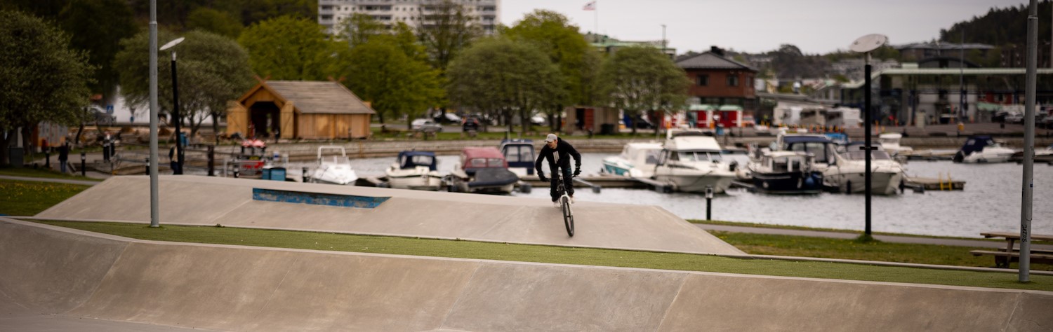En ung gutt sykler BMX i en skatepark.