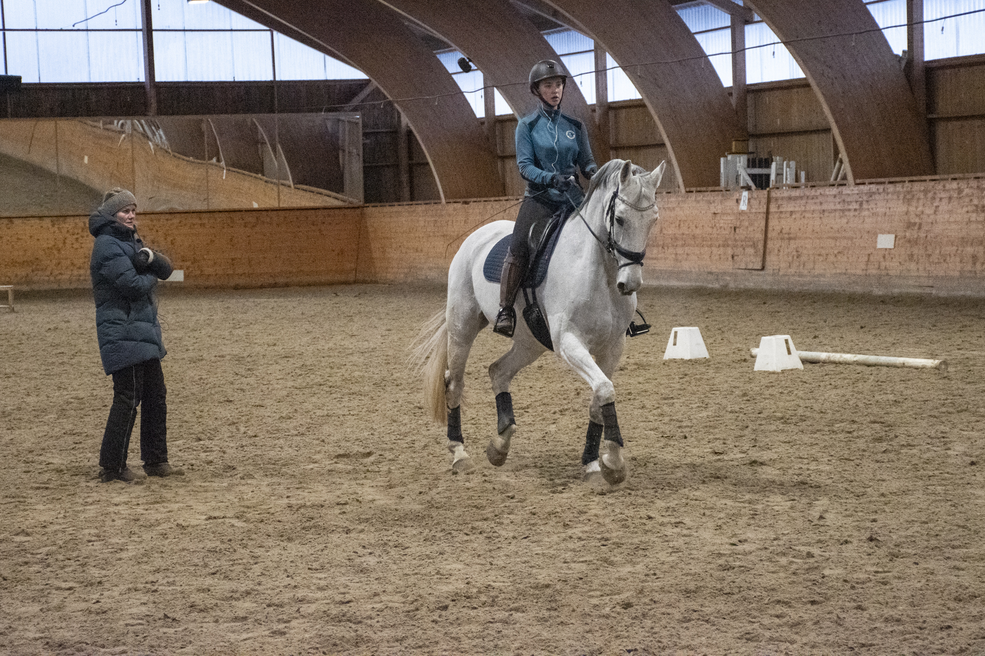 Dressurtrener observerer dressurelev i aksjon i ridehallen