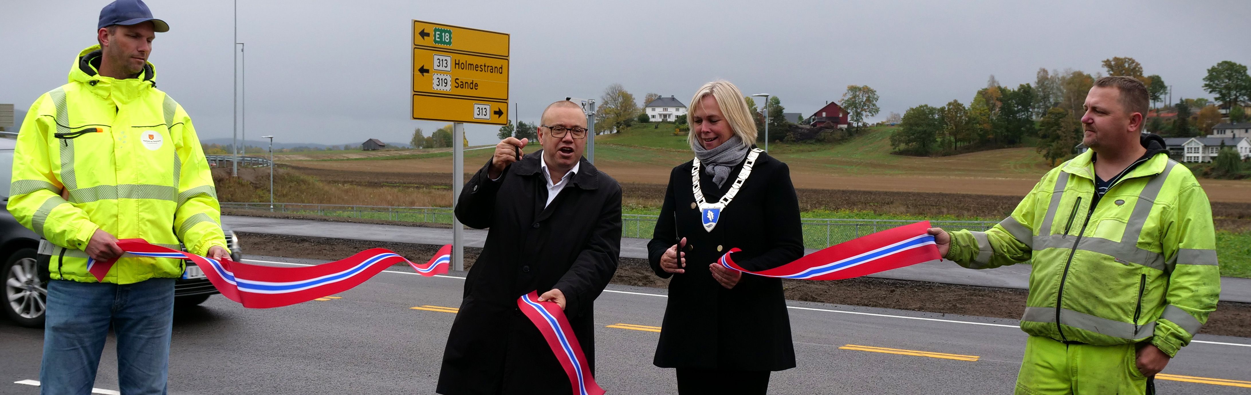 Snora klippes av Arve Høiberg og Elin Gran Weggesrud, mens byggeleder fra fylkeskommunen, Sveinung Lande, og anleggsleder hos entreprenør Br. Thorkildsen, Arvid Egra, holder snora med fargene til det norske flagget.