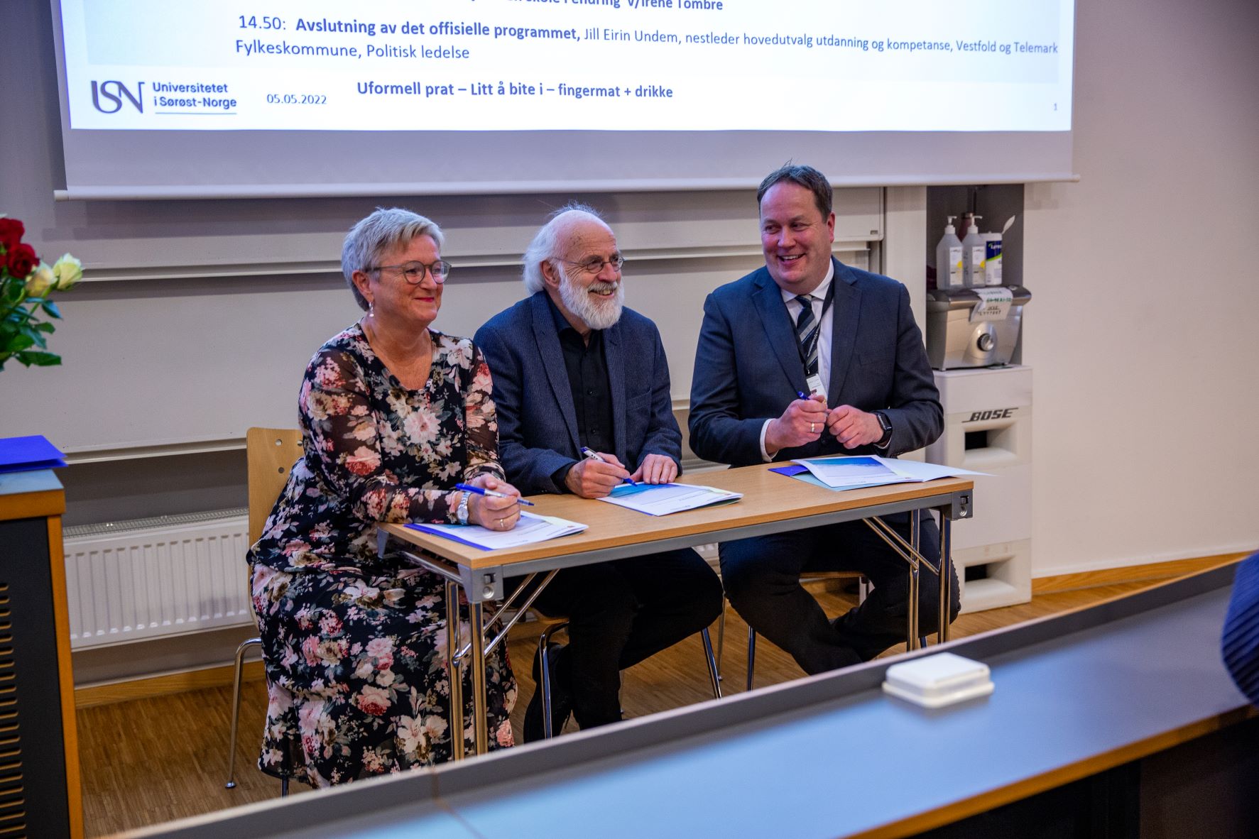 Tre rektorer ved pult som signerer avtaler.