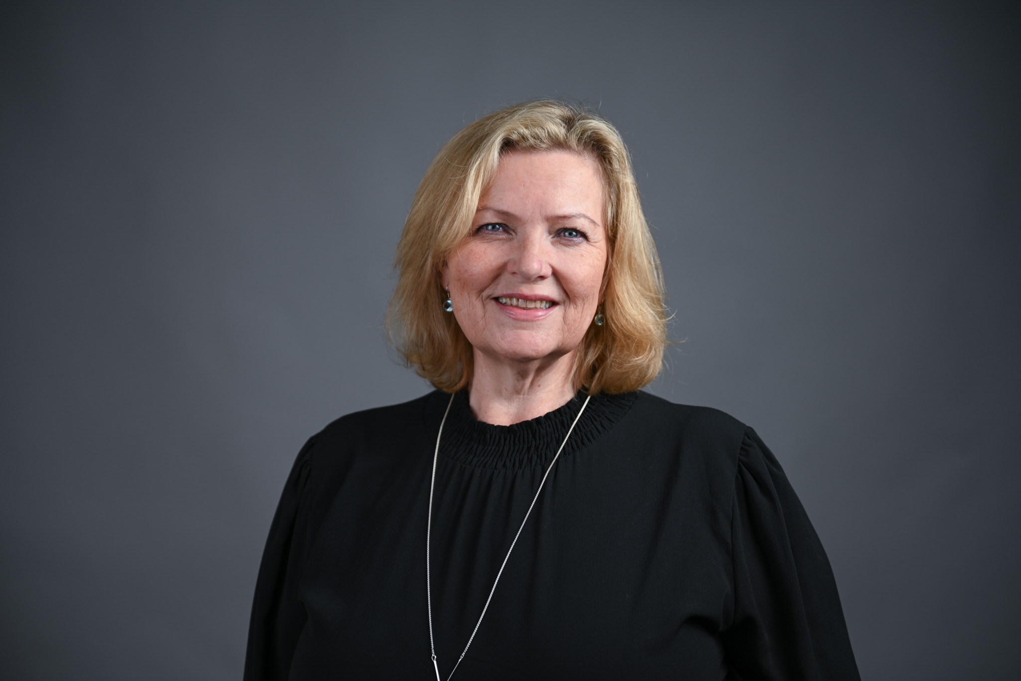 Portrett av dame med grå bakgrunn. Foto: Anders Palmer Holmen